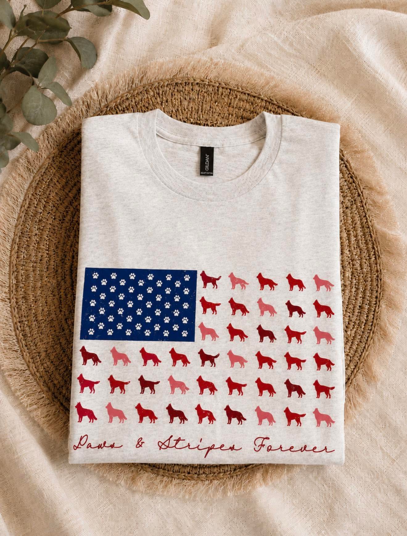 Folded heather tee with a paw-print American flag design reading Paws & Stripes Forever