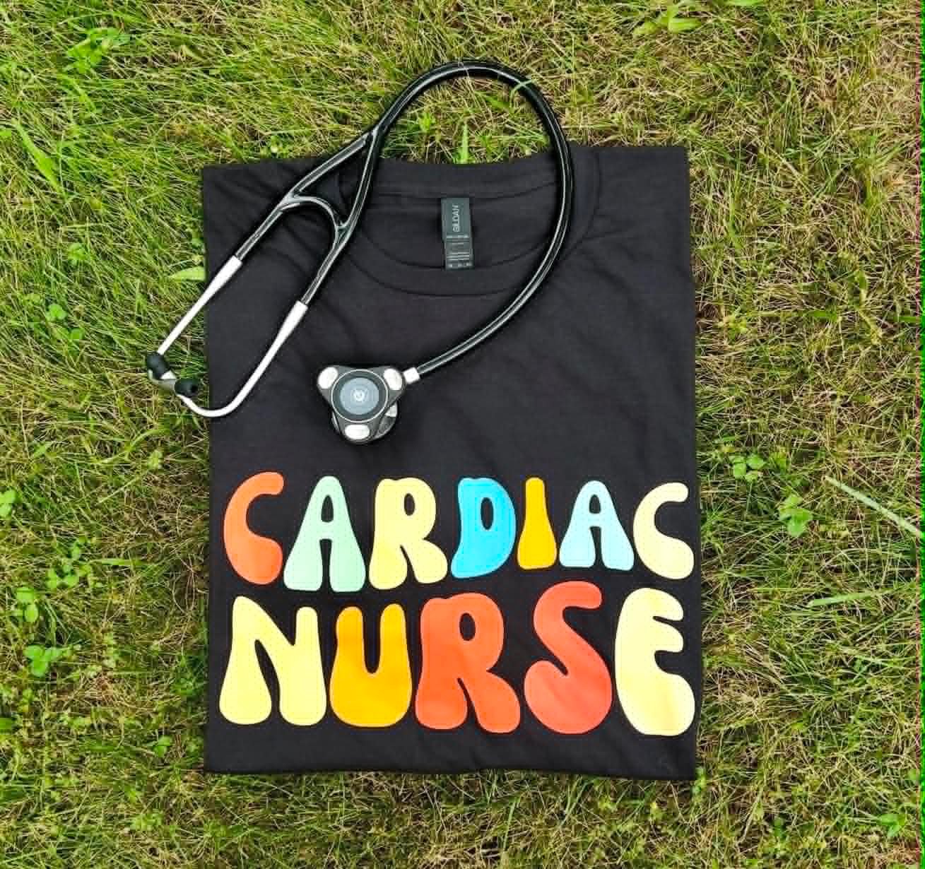 Black Gildan tee with a retro rainbow print reading Cardiac Nurse